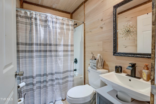 full bathroom featuring sink, toilet, shower / bathtub combination with curtain, and wood walls