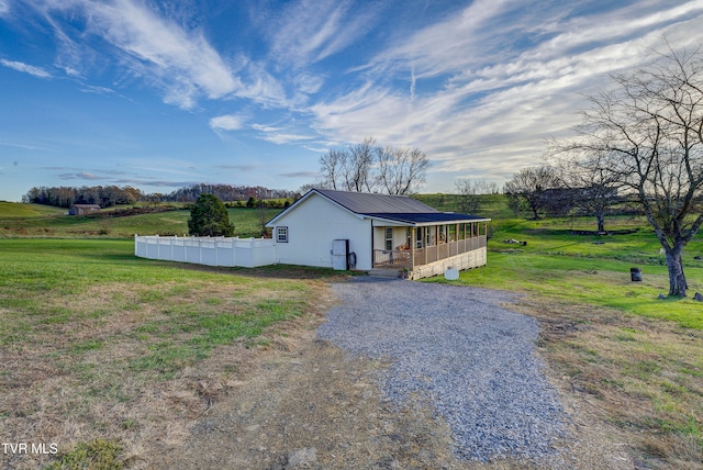 view of home's exterior featuring a yard and a rural view