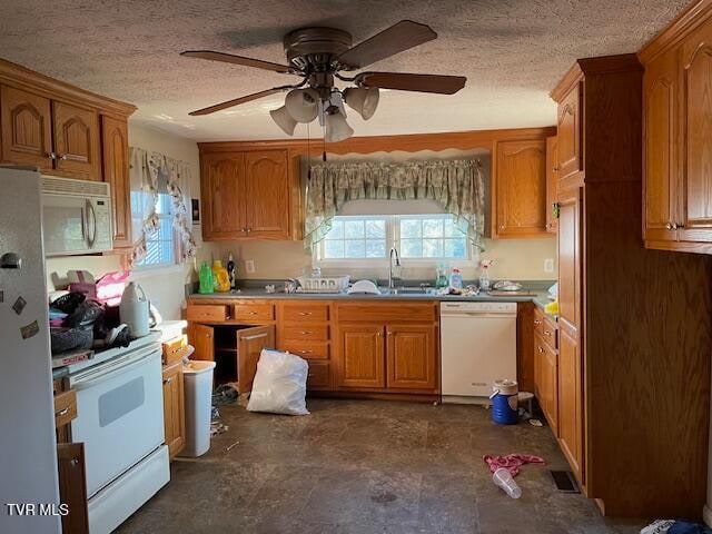 kitchen featuring a textured ceiling, ceiling fan, white appliances, and sink