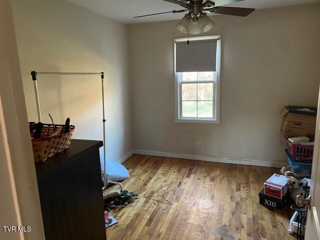 interior space with hardwood / wood-style floors and ceiling fan