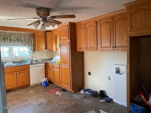 kitchen featuring white dishwasher, ceiling fan, sink, and a textured ceiling