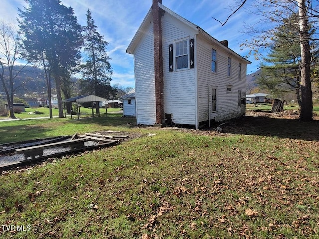 view of home's exterior featuring a gazebo and a lawn