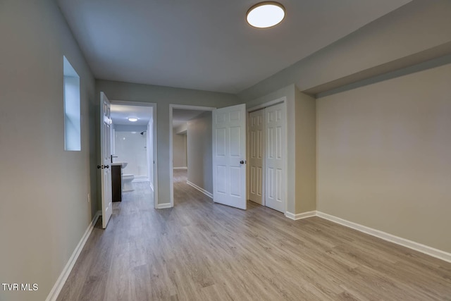 unfurnished bedroom featuring a closet and light hardwood / wood-style flooring