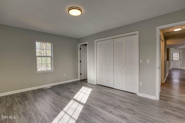 unfurnished bedroom with light hardwood / wood-style floors and a closet