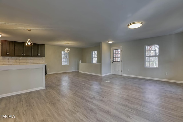 unfurnished living room with hardwood / wood-style floors