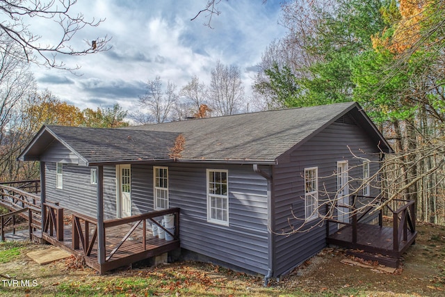 rear view of property featuring a deck