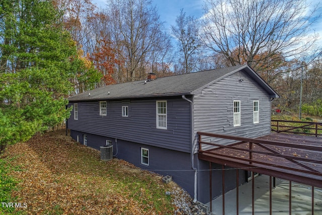 view of side of property featuring a deck and central air condition unit