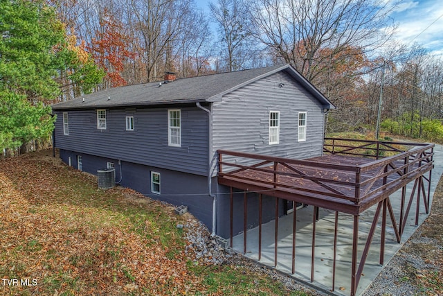 back of property featuring a deck and cooling unit