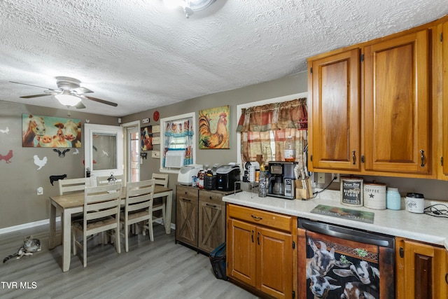 kitchen featuring a textured ceiling, light hardwood / wood-style flooring, beverage cooler, and ceiling fan