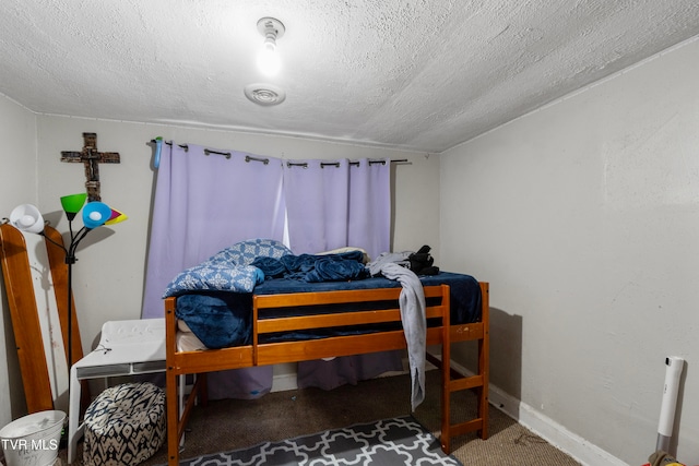 bedroom featuring carpet floors and a textured ceiling