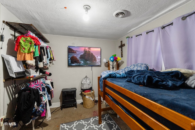 carpeted bedroom featuring a textured ceiling