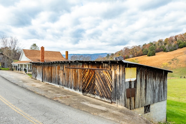 view of property exterior with a mountain view