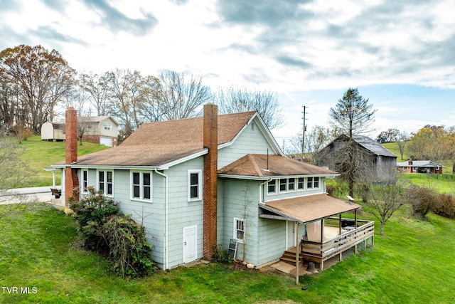 back of property with a lawn