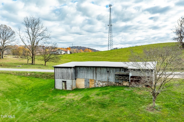 view of outbuilding with a yard