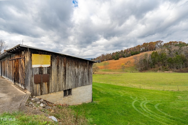 view of outbuilding with a yard and a rural view