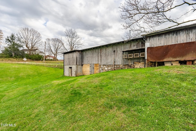 view of outdoor structure featuring a lawn