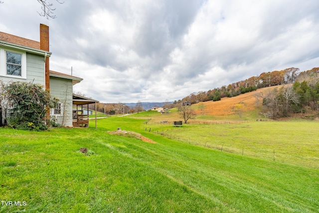 view of yard featuring a mountain view and a rural view