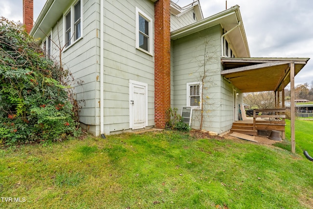 rear view of house featuring a yard