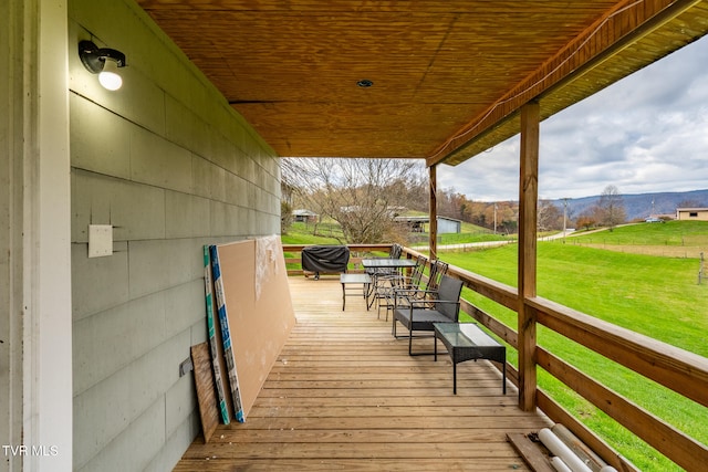 wooden deck featuring a yard