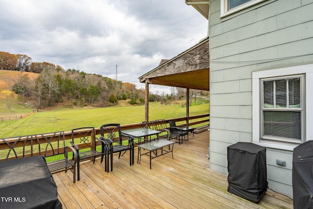 wooden deck featuring a lawn