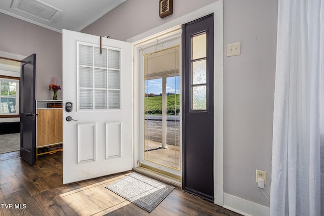 doorway to outside with dark hardwood / wood-style flooring and crown molding