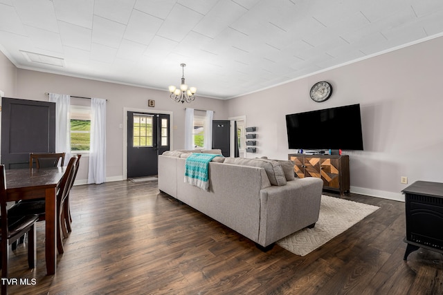 living room featuring a chandelier, dark hardwood / wood-style floors, and crown molding