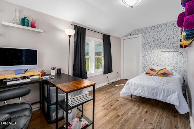 bedroom featuring wood-type flooring and lofted ceiling