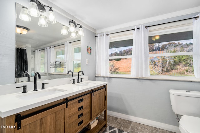 bathroom featuring vanity and toilet