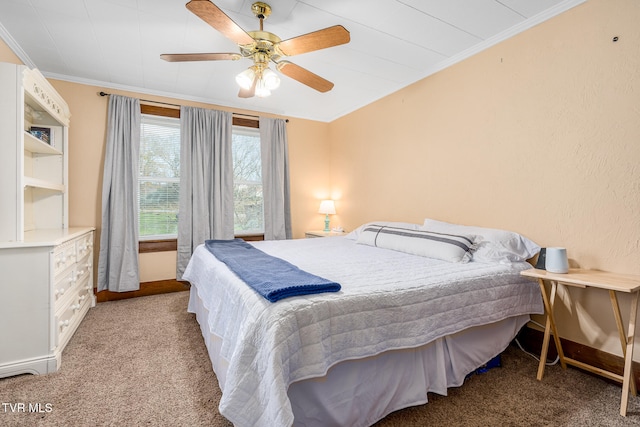 carpeted bedroom with ceiling fan and ornamental molding