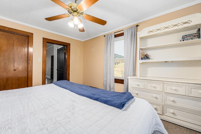 bedroom with ceiling fan, crown molding, and a closet