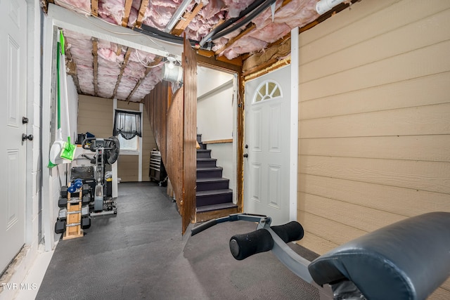 exercise area featuring wood walls