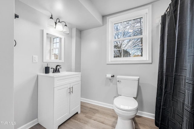 bathroom with vanity, hardwood / wood-style flooring, and toilet