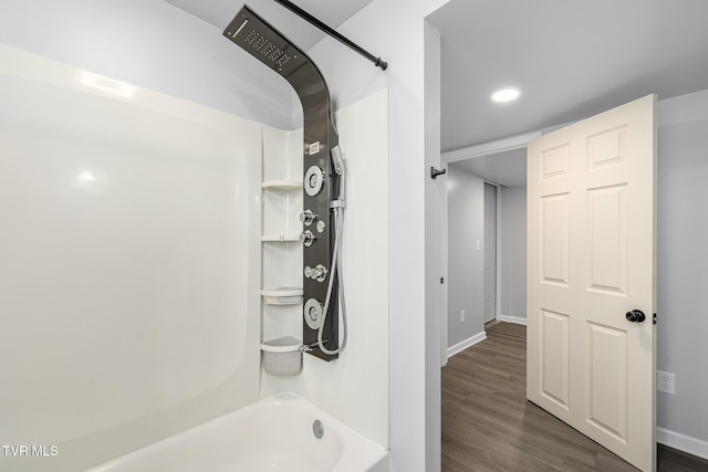 bathroom with shower / washtub combination and hardwood / wood-style floors