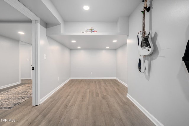 basement with light hardwood / wood-style flooring