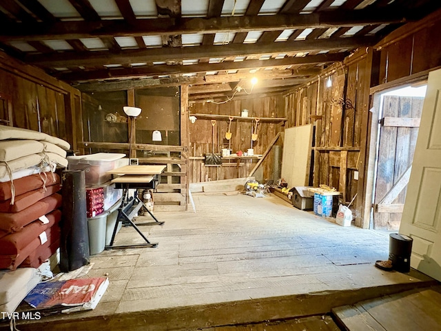 interior space with wooden walls and a healthy amount of sunlight