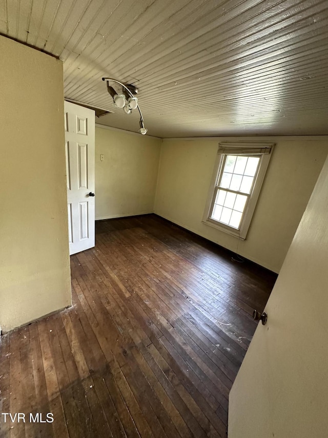 unfurnished room with dark hardwood / wood-style floors