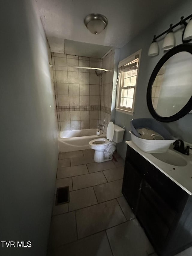 full bathroom featuring tile patterned floors, toilet, vanity, and tiled shower / bath