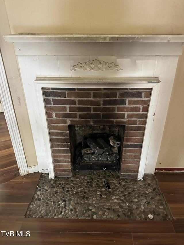 room details with a fireplace and hardwood / wood-style floors