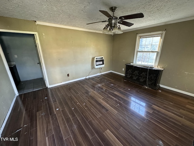 unfurnished room featuring dark wood-type flooring, ceiling fan, ornamental molding, a textured ceiling, and heating unit