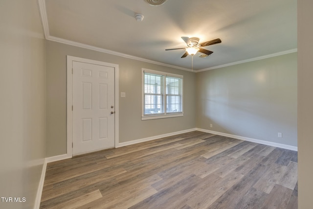 foyer with ceiling fan, wood-type flooring, and ornamental molding