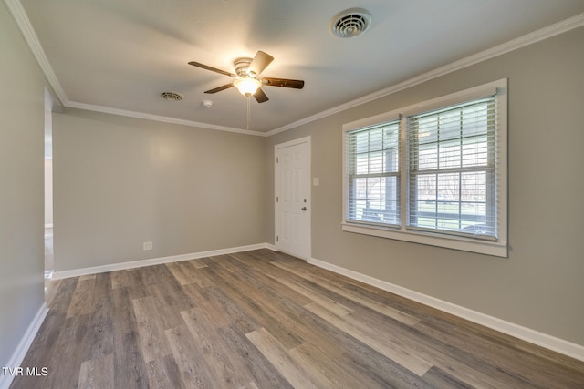 empty room featuring hardwood / wood-style floors, ceiling fan, and crown molding