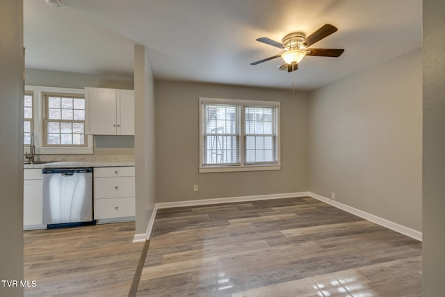 kitchen with ceiling fan, sink, light hardwood / wood-style flooring, dishwasher, and white cabinetry