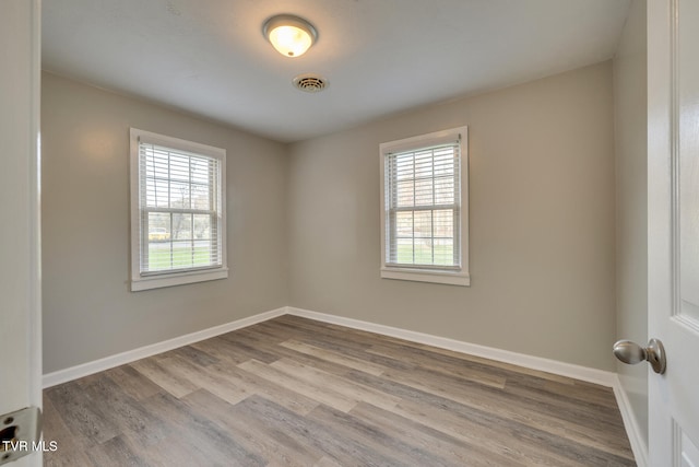 unfurnished room featuring light hardwood / wood-style flooring and a wealth of natural light