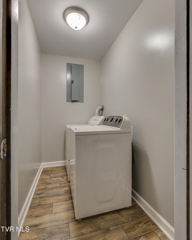 washroom with separate washer and dryer, wood-type flooring, and electric panel