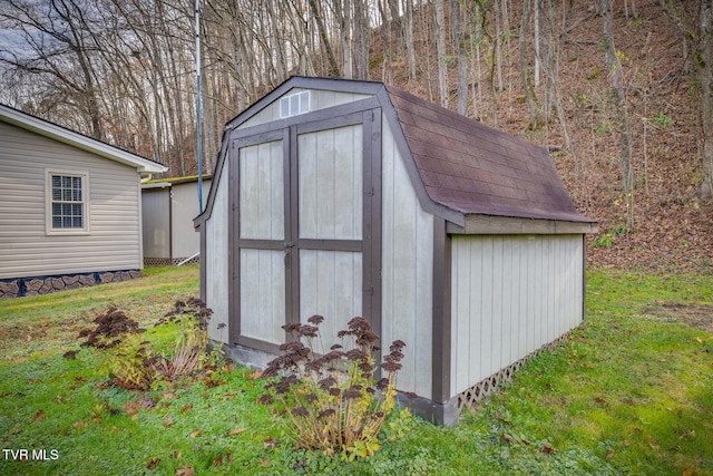 view of outbuilding featuring a lawn