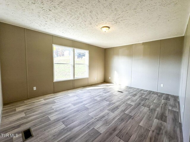 307 Bungalow Dr, Dandridge, TN 37725 - empty room featuring wood-type flooring and a textured ceiling