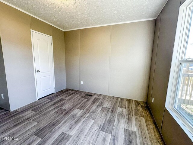 307 Bungalow Dr, Dandridge, TN 37725 - unfurnished room with ornamental molding, a textured ceiling, and light wood-type flooring