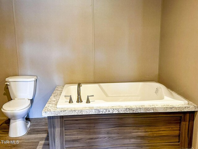 307 Bungalow Dr, Dandridge, TN 37725 - bathroom with a tub to relax in, hardwood / wood-style flooring, and toilet