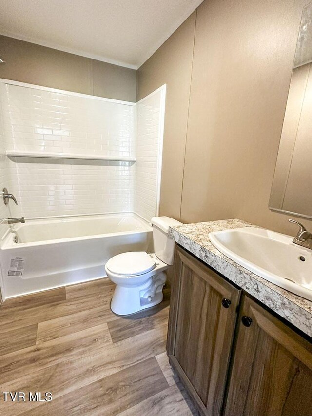 307 Bungalow Dr, Dandridge, TN 37725 - full bathroom featuring tiled shower / bath, vanity, wood-type flooring, and toilet