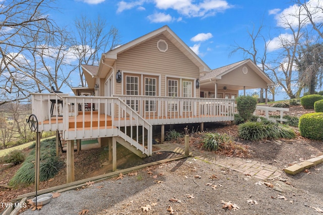 rear view of house featuring a wooden deck